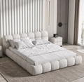 Cumulo cloud-tufted upholstered bed styled in a refined modern bedroom
