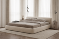 Roundel rounded upholstered platform bed styled in a calm modern bedroom