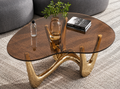 Topazo amber glass coffee table styled beside a modern curved sofa