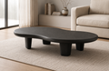 Voidstone sculptural coffee table styled in a dark modern living room